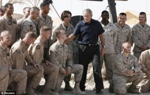 President George W. Bush with U.S. forces after authorizing a troop surge in Iraq. / Reuters