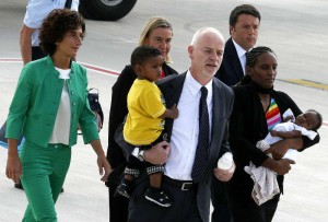 Meriam Yahya Ibrahim of Sudan carries one of her children, as she arrives at Ciampino airport in Rome on July 24 with Lapo Pistelli, Italy’s vice minister for foreign affairs, holding her other child, Italian Prime Minister Matteo Renzi, right, and his wife Agnese, left, and Foreign Affairs minister Ferica Mogherini.  /Remo Casilli/Reuters