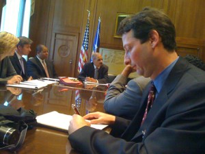 Brian Levin takes notes at meeting with former Attorny General Eric Holder.