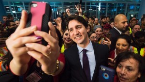 Canadian Prime Minister Justin Trudeau welcomes Syrian migrants arriving at Pearson International Airport in Toronto.