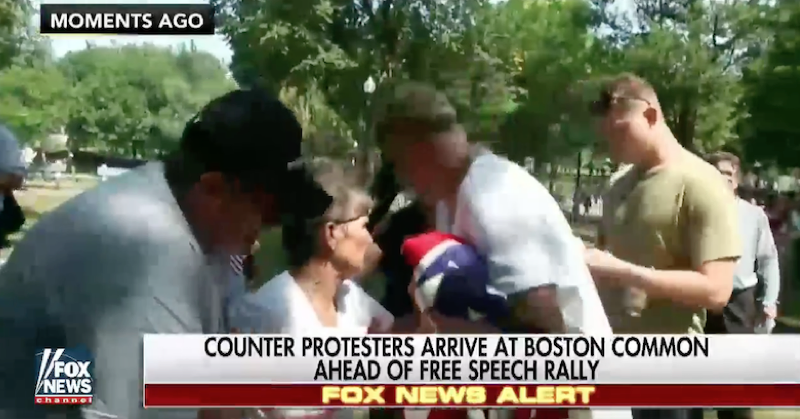 Columnist Jeff Kuhner interviews now-famous lady with a flag at Boston rally